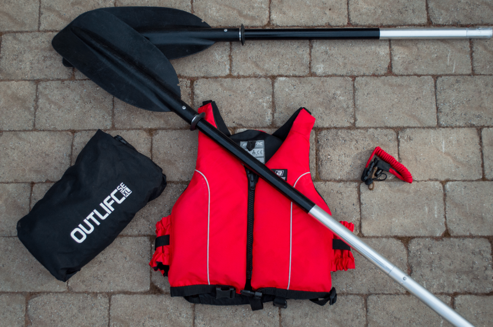 Premium kayak equipment laid out on a wooden dock